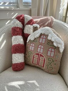 a house pillow sitting on top of a couch next to a christmas stocking pole