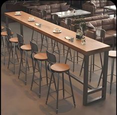 a long table with four stools in front of it