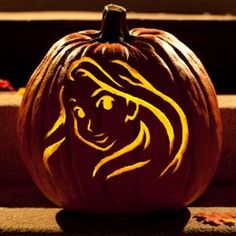 a carved pumpkin with the face of a lion painted on it's front and side