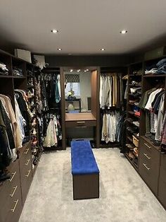 a walk in closet filled with lots of clothes