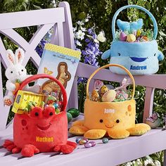 three stuffed animals sitting next to each other on a bench with easter baskets in front of them