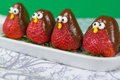 three chocolate covered strawberries in the shape of birds