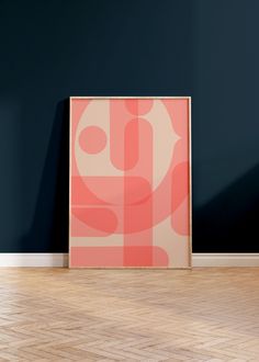 an abstract painting on the wall next to a wooden floor