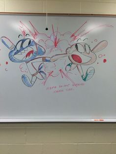 a drawing of two cartoon characters on a whiteboard