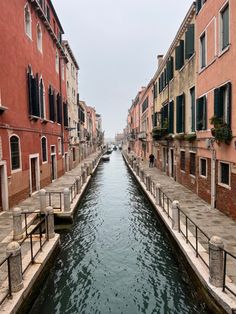 a narrow canal with several boats in it