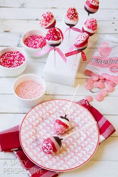 valentine's day desserts are displayed on plates and napkins