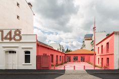 an empty street with red and white buildings