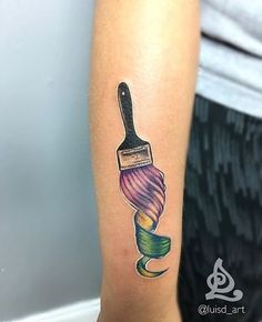 a person with a tattoo on their arm has a brush in the shape of a flower