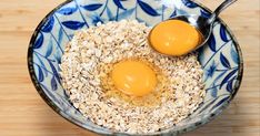 two eggs are in a bowl with oats