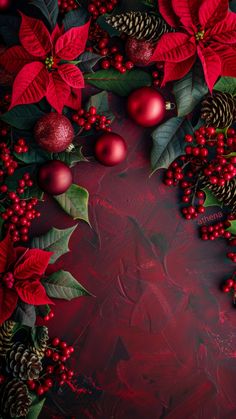 christmas decorations with poinsettis and pine cones on a dark red background, top view