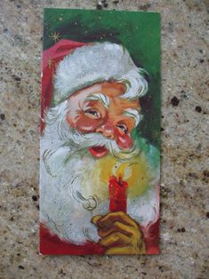 a painting of santa claus holding a lit candle in his right hand and making a funny face