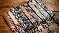 a bunch of different colored belts sitting on top of a wooden table