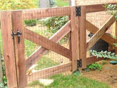 a wooden gate that has a chicken in it