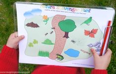 a person holding up a book with an image of a tree and leaves on it