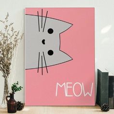 a pink canvas with a cat on it and the word meow written in white