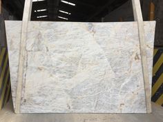 white marble is stacked on top of each other in a storage area at a factory