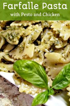 pasta with pesto and chicken on a white plate