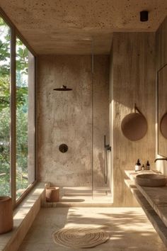 a bathroom with two sinks and a large window in it's side wall that looks out onto the outdoors