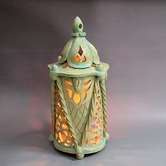 a decorative tea light holder on a gray background