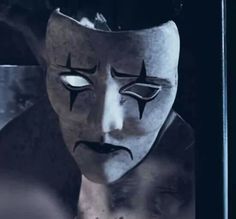 a creepy mask is shown in front of a mirror