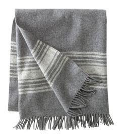 a blue and white blanket with fringes