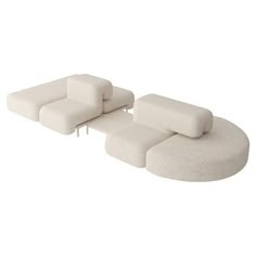 a white couch with four pillows on it's back and one arm folded over the other