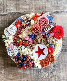 a platter filled with lots of food on top of a wooden table