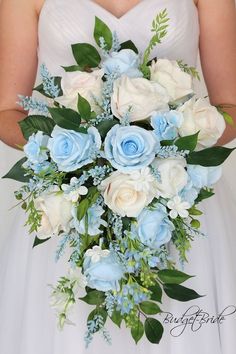 a bride holding a bouquet of blue and white flowers