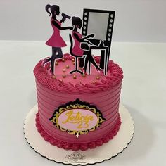 a pink birthday cake with an image of a woman getting ready for her makeup job