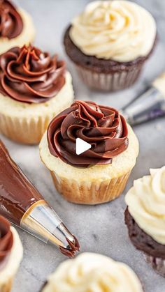 cupcakes with chocolate frosting and a pen