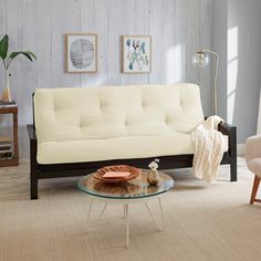 a living room with two chairs and a white couch in it's center area