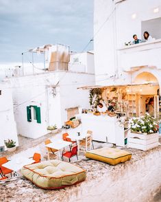 an outdoor seating area on the roof of a building