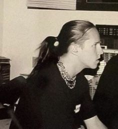 two people sitting at a desk in an office