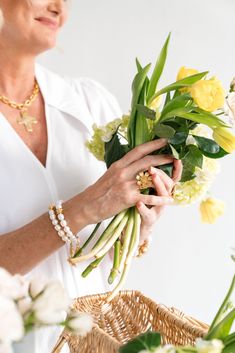 a woman is holding flowers in her hands