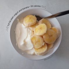 a white bowl filled with yogurt and banana slices