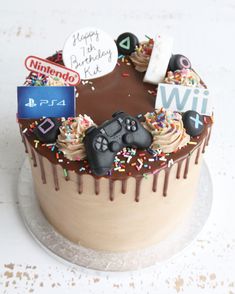 a birthday cake with chocolate frosting, sprinkles and video game controllers