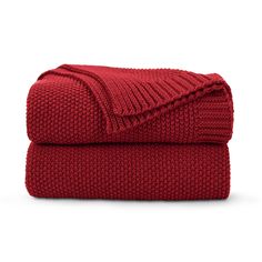 the red blanket is folded on top of each other