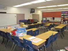 an empty classroom with desks and chairs