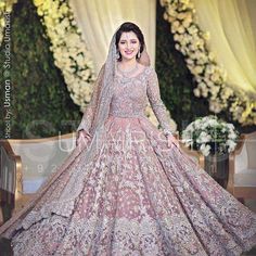 a woman in a wedding dress posing for the camera