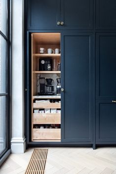 an open cabinet in the corner of a room