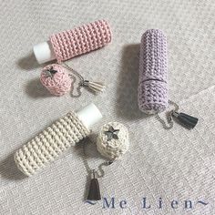 three crocheted items are laying on the floor next to each other and one has a tassel