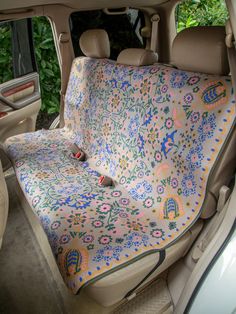 a car seat covered in a colorful blanket