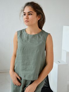 "Midnight blue sleeveless linen top. Handmade linen basic tank top. Creating this collection I was thinking, first of all, about comfort and feelings of those who would wear it. Natural high-quality softened linen, well-considered details and good quality of seams - this is exactly what will help your body to feel taken care of. For stitching parts, I never use an overlock, all internal seams are French (double). This fabric is certified Oeko-Tex Standard 100 03.0.4362. The top made of high-qual Sleeveless Linen Top For Everyday, Casual Sleeveless Flax Tank Top, Relaxed Fit Linen Sleeveless Blouse, Everyday Sleeveless Linen Top, Everyday Linen Tank Top, Everyday Sleeveless Linen Tank Top, Solid Linen Summer Tank Top, Summer Linen Fitted Tank Top, Green Sleeveless Linen Top