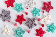 several crocheted ornaments are arranged on a white surface with red, green and blue decorations