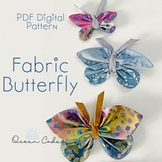 three paper butterflies with the words fabric butterfly written below them in blue, yellow and pink