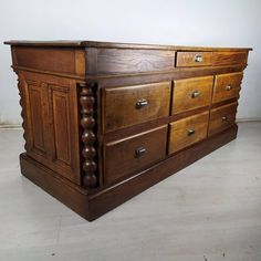 a large wooden dresser sitting on top of a white floor