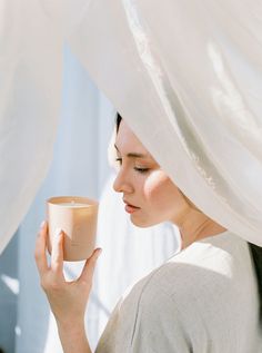 a woman holding a cup in her hands