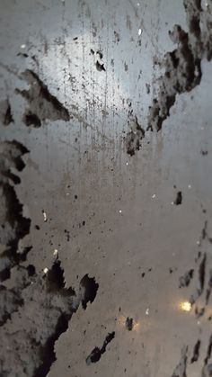 an image of the surface of water that has been covered in mud and dirt with light reflecting on it