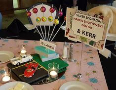 a table set with plates, candles and decorations for a children's birthday party