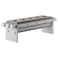 a bench made out of metal and concrete with four holes on the backrests